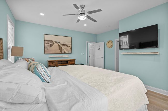 Bedroom with baseboards, recessed lighting, ceiling fan, and wood finished floors | Image 13