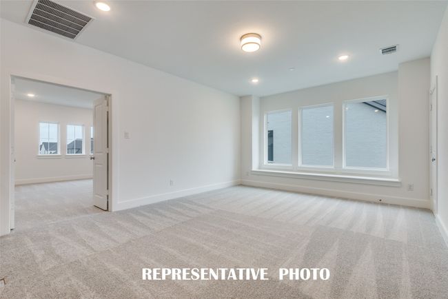 This light filled game room paired with a spacious media room offers the perfect place for endless family fun! REPRESENTATIVE PHOTO. | Image 15