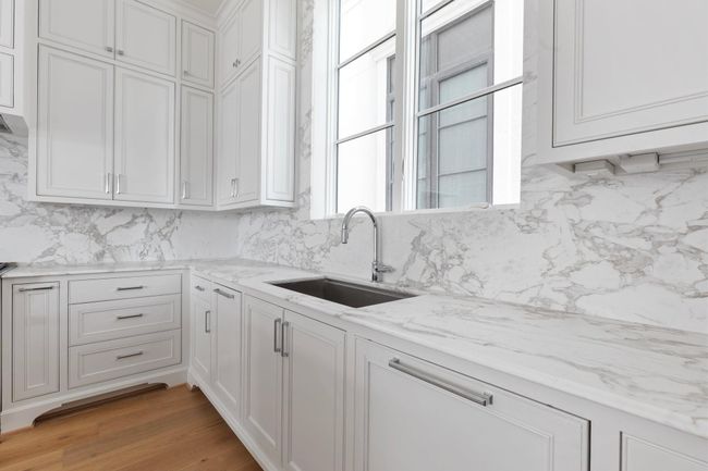 High-end luxury details include such features as imported marble countertops and backsplash with under-cabinet lighting + hidden outlet strips to maintain the clean and modern look. | Image 18
