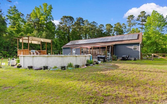 Back of property featuring roof mounted solar panels | Image 25