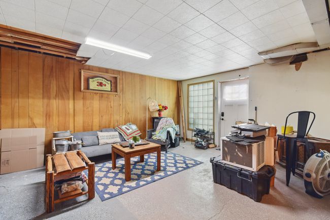 Living room featuring wood walls | Image 27