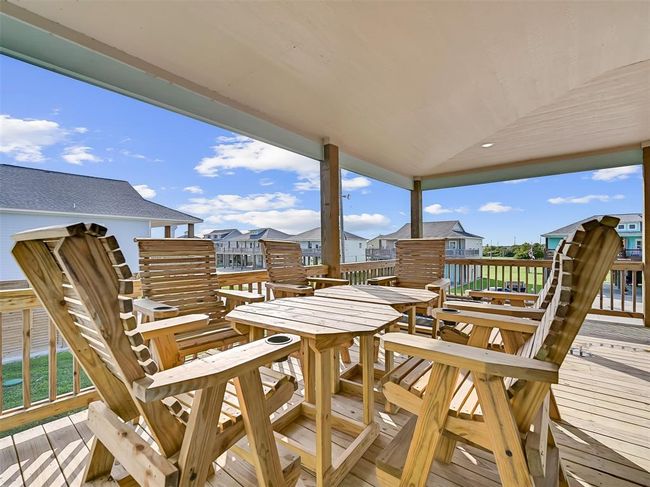 Enjoy al fresco dining on the spacious covered deck, complete with bar-height seating for 6—perfect for morning coffee, sunset dinners, or evening cocktails with friends. | Image 6