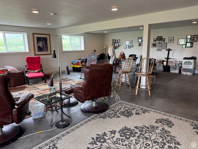 Basement living area featuring concrete flooring and recessed lighting | Image 15