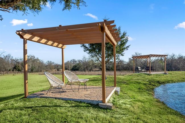 A second pergola provides another spot to sit back and enjoy the pond and surrounding landscape. | Image 40