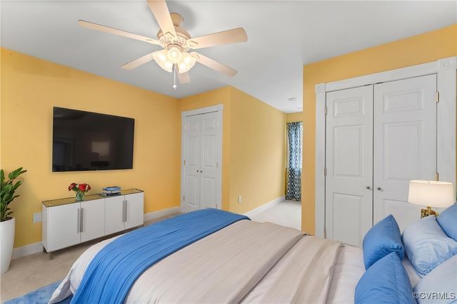 Bedroom featuring multiple closets, carpet floors, and ceiling fan | Image 14