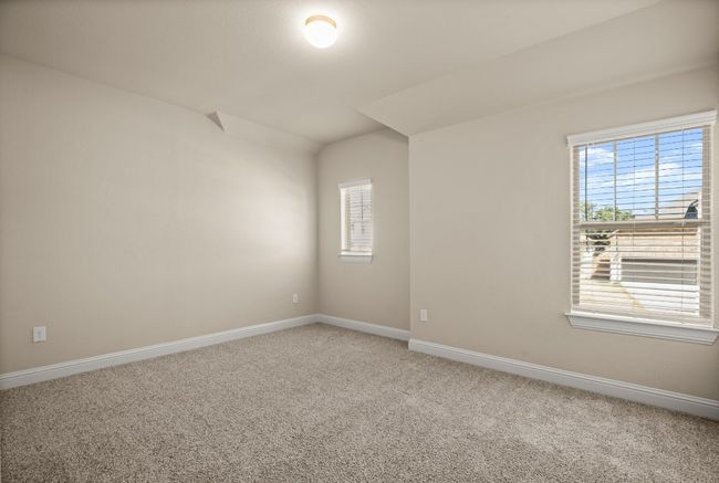 Carpeted spare room featuring vaulted ceiling and baseboards | Image 25