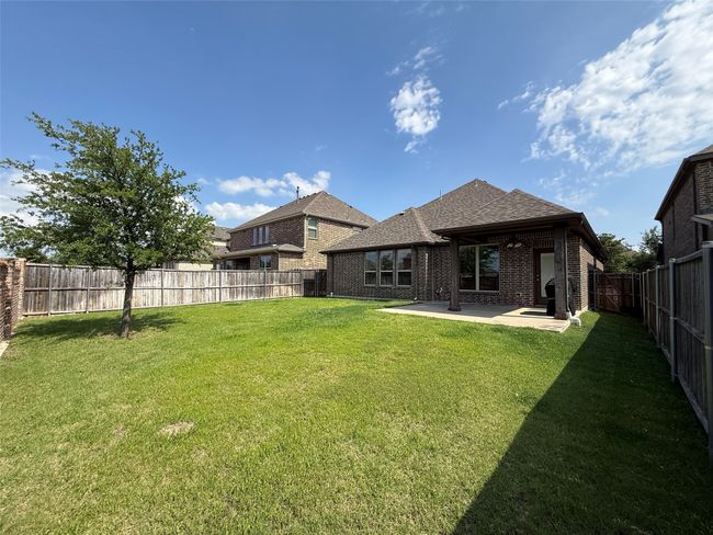 Rear view of property featuring a patio, brick siding, and roof with shingles | Image 16