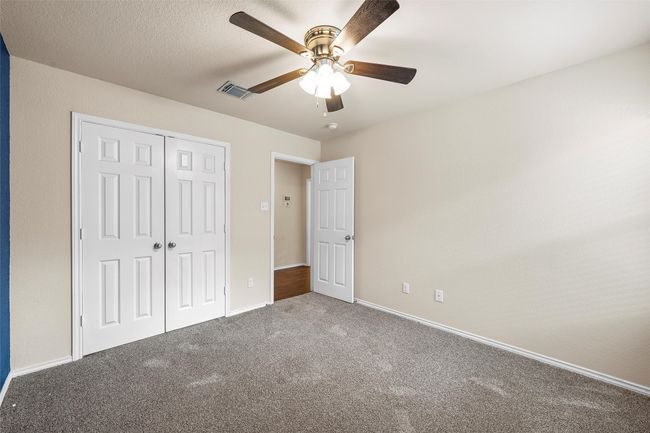 Unfurnished bedroom with carpet flooring, a closet, and ceiling fan | Image 25