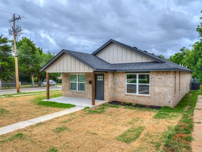 View of front of house with a front yard and central AC unit | Image 1