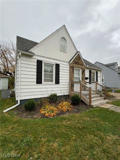 View of front of property featuring a front yard and a deck | Image 3