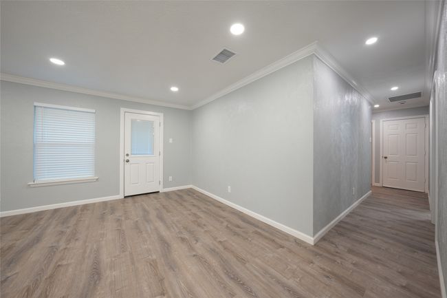 Unfurnished room featuring recessed lighting, visible vents, wood finished floors, and baseboards | Image 7