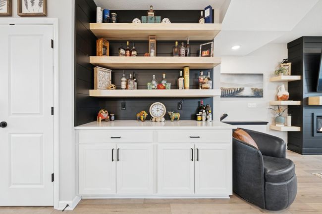 Custom-built owner’s bar featuring sleek lighting and a bold black accent wall, creating a stylish, modern vibe perfect for entertaining. | Image 17
