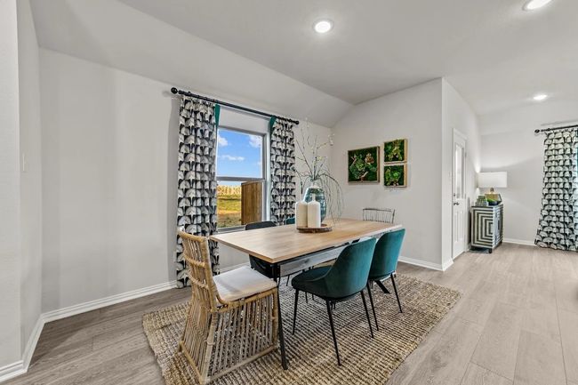 Dining room featuring light wood-type flooring, lofted ceiling, baseboards, and recessed lighting | Image 15