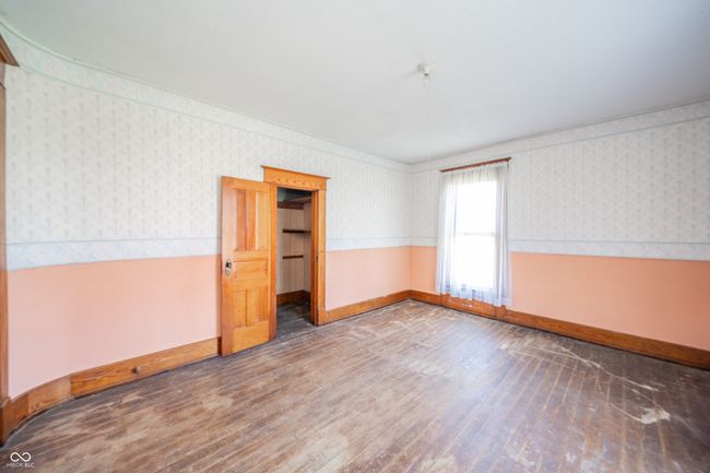 empty room with baseboards, wainscoting, wood finished floors, and wallpapered walls | Image 14