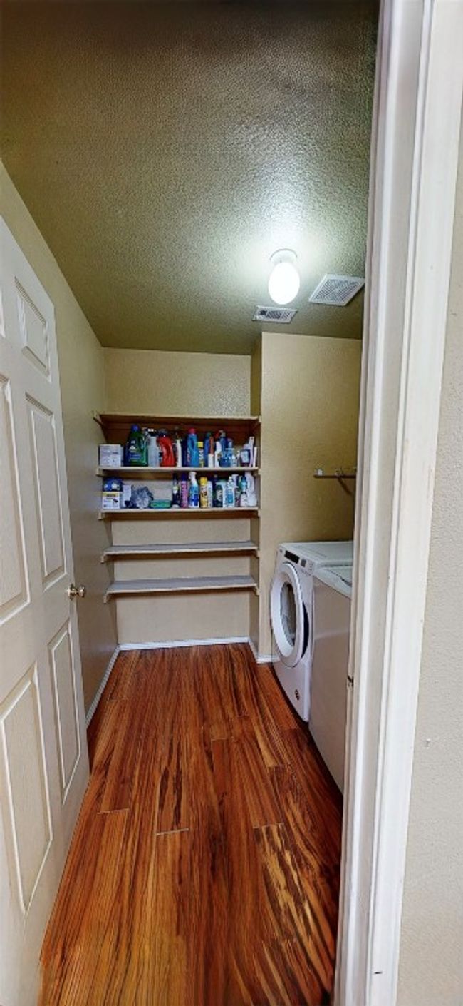 Washroom with washing machine and clothes dryer, wood finished floors, and a textured ceiling | Image 17