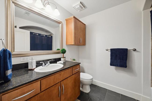 The secondary full bath, featuring a tub/shower combo, is conveniently located near the study area for guest an serves the secondary bedroom. | Image 14