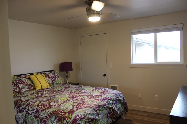 Bedroom with wood finished floors and ceiling fan | Image 20