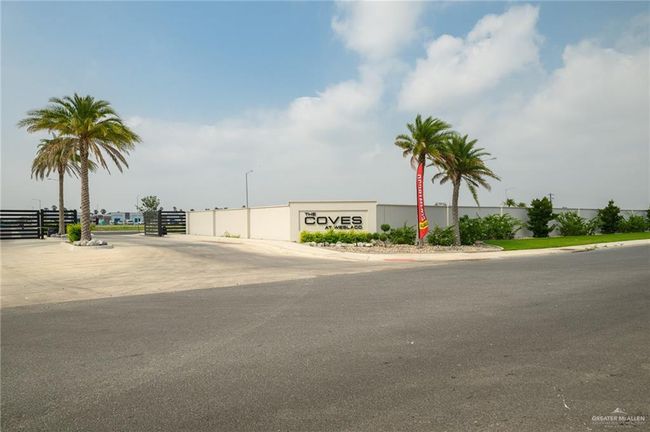 View of asphalt road featuring street lights and curbs | Image 23