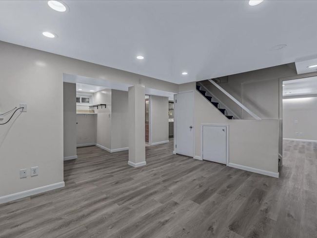 Unfurnished living room with stairway, wood finished floors, and recessed lighting | Image 27