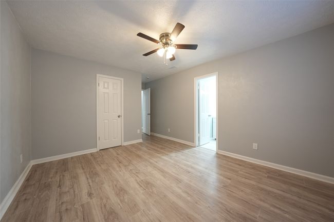 Spare room with baseboards, visible vents, ceiling fan, and light wood-style floors | Image 13