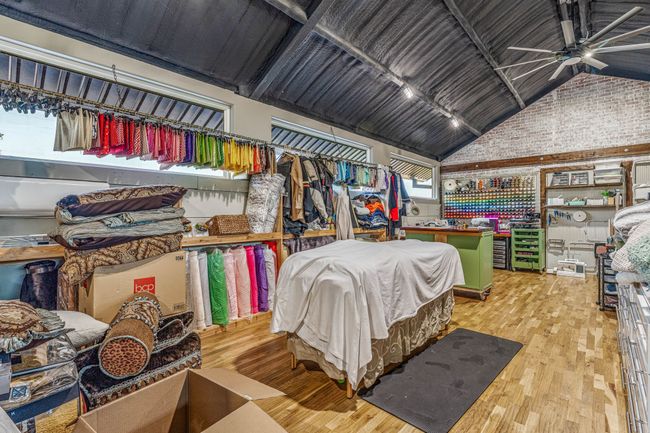 Bedroom with high vaulted ceiling and wood-type flooring | Image 6