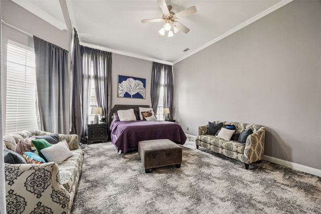 Carpeted bedroom with ornamental molding and a ceiling fan | Image 20