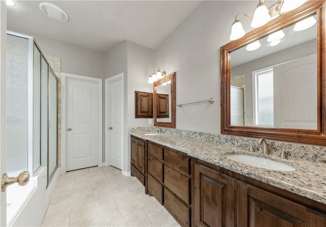 Full bathroom with a shower stall, double vanity, and tile patterned flooring | Image 21