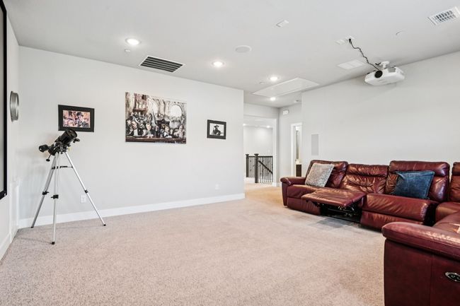 Carpeted living room with attic access and recessed lighting | Image 23