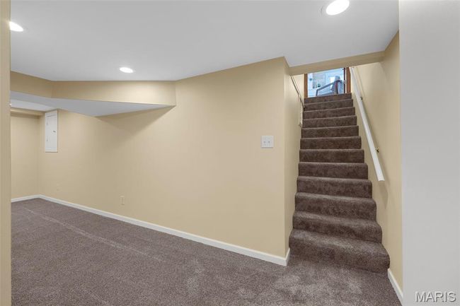 Below grade area with carpet floors, stairs, recessed lighting, and electric panel | Image 24