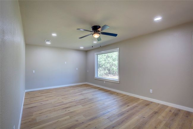 Spare room featuring a ceiling fan, baseboards, recessed lighting, and light wood-style floors | Image 5