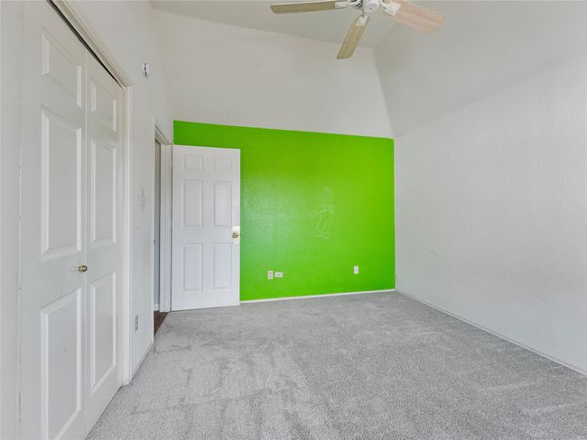 Unfurnished bedroom featuring carpet, a ceiling fan, lofted ceiling, and a closet | Image 20