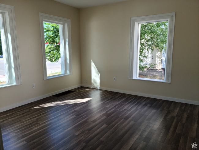Unfurnished room featuring dark wood-style floors and baseboards | Image 16