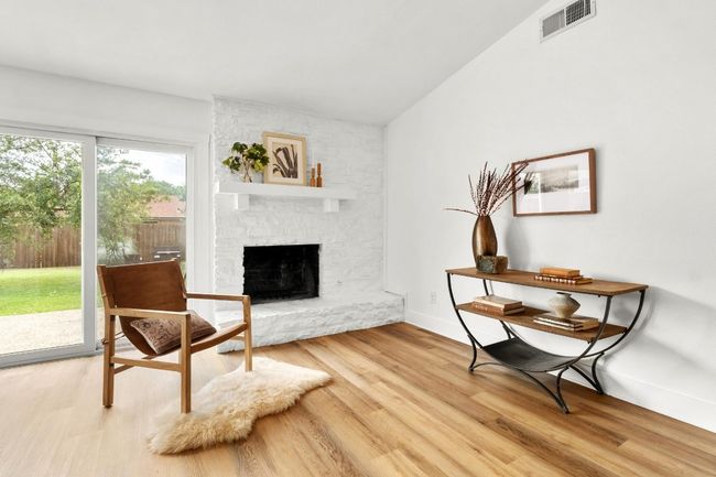Sitting room featuring a fireplace and light wood-style flooring | Image 4