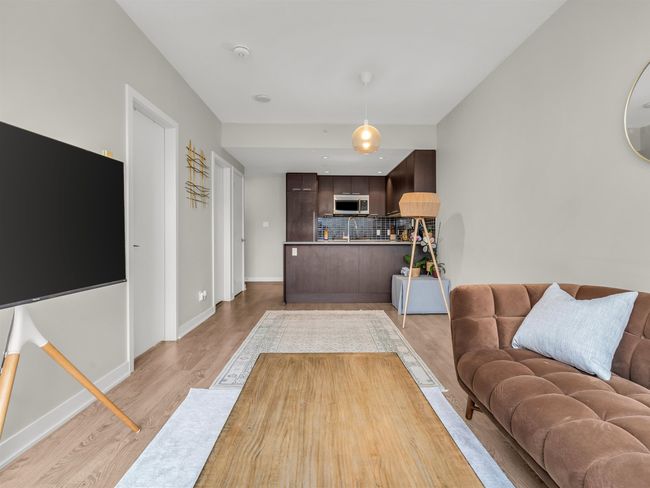 Living area with baseboards and light wood-style floors | Image 7