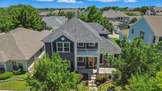 Traditional-style home with a shingled roof, a balcony, and a residential view | Image 40
