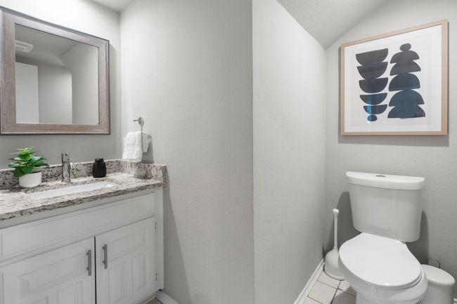 Bathroom with vanity, toilet, tile flooring, lofted ceiling, and baseboards | Image 25