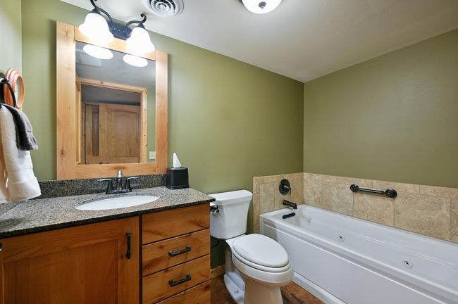 The bathroom on this level is fabulous! It has a granite vanity, a whirlpool tub, a separate shower and a sauna. | Image 50