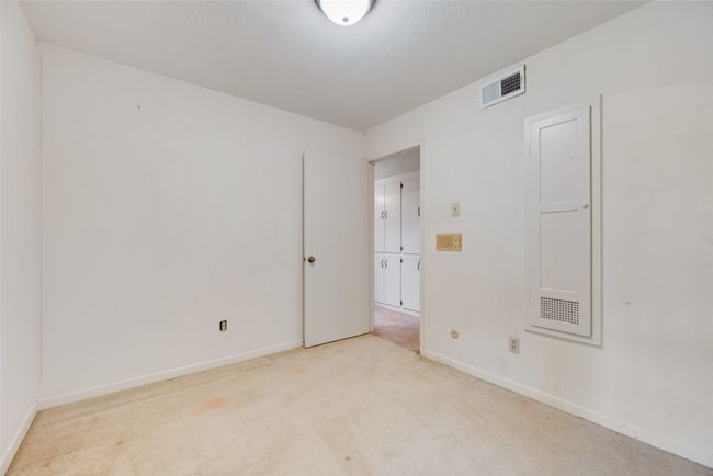 Empty room featuring light carpet and baseboards | Image 24