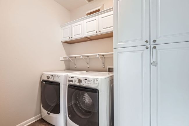 Downstairs laundry room equipped with laundry chute and cabinets | Image 31