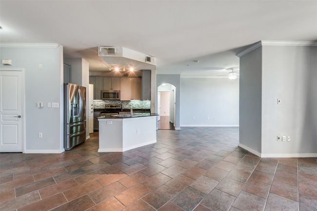 Kitchen with stainless steel appliances, ornamental molding, ceiling fan, and decorative backsplash | Image 24
