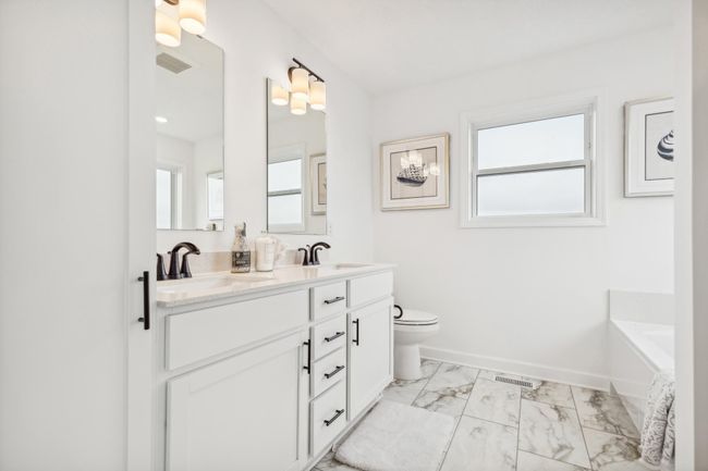 (Photo of a decorated model, actual homes finishes will vary) The primary bath features a double-vanity, a shower, and a separate soaking tub. | Image 15