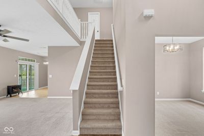 Upon entering the home you're immediately greeted by the dining, staircase, & main living room! | Image 3