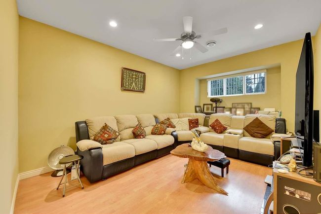 Living room with wood finished floors, ceiling fan, recessed lighting, and baseboards | Image 28