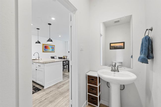 Bathroom with dual sinks and wood-type flooring | Image 25