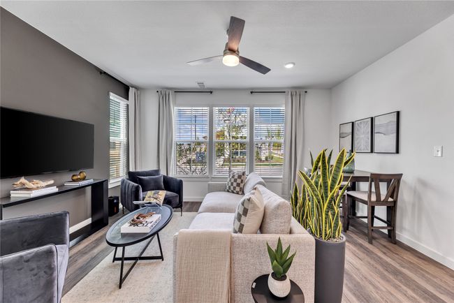 Living area featuring ceiling fan, wood finished floors, visible vents, and baseboards | Image 5