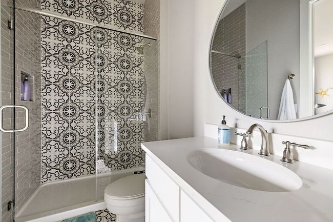 Bathroom with toilet, a stall shower, and vanity | Image 24