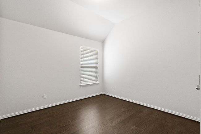 Empty room featuring vaulted ceiling and dark wood-style flooring | Image 21