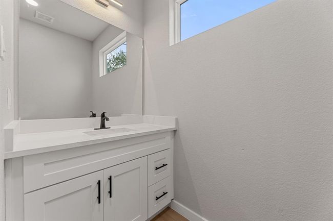 Downstairs half bath. Located just inside the front door, this guest bathroom offers convenience andprivacy. | Image 9