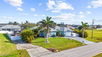 View of front facade with a front lawn and a garage | Image 3