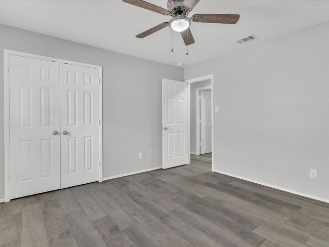 Unfurnished bedroom featuring wood finished floors, baseboards, a closet, and ceiling​​‌​​​​‌​​‌‌​‌‌​​​‌‌​​‌‌​‌​​​​​‌ fan | Image 16